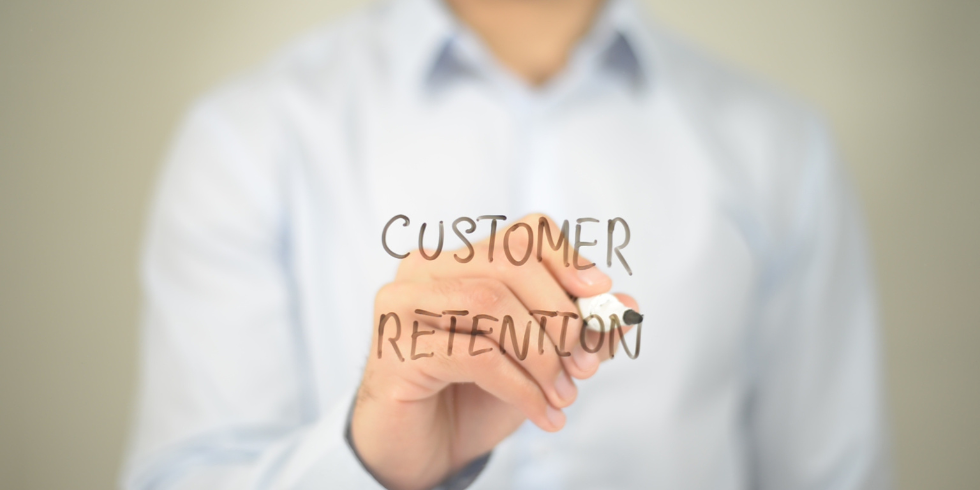 Customer Retention_980x490 Hand writing customer retention on glass
